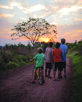 Latin American boys take in a spectacular sunset